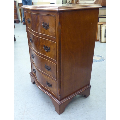 106 - A modern serpentine front walnut finished four drawer tallboy, raised on bracket feet  31