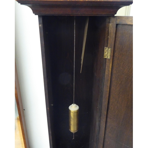 113 - An early 20thC oak cased granddaughter clock, the arched hood decorated with barleytwist columns, th... 