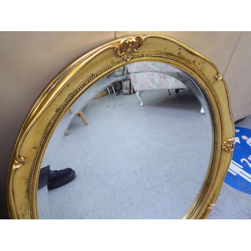 121 - Two dissimilar bevelled glass mirrors, in gilt frames  21