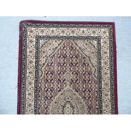 128 - A modern Persian woollen rug, decorated in colours  59