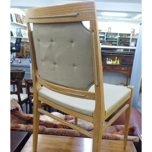 148 - A set of ten modern designer light oak framed dining chairs chairs with square backs, part button up... 