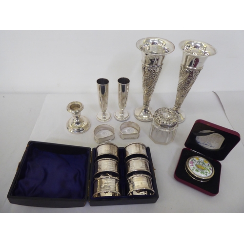 151 - Silver collectable items: to include a set of six engine turned napkin rings; and a pair of loaded E... 