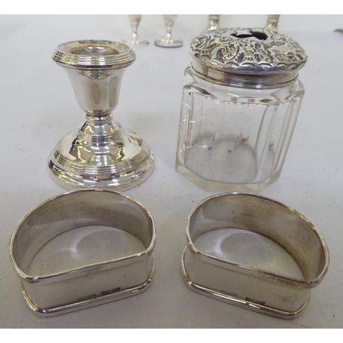 151 - Silver collectable items: to include a set of six engine turned napkin rings; and a pair of loaded E... 