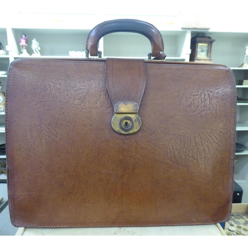 152 - Four items of 20thC luggage: to include a brown hide doctor's style bag 