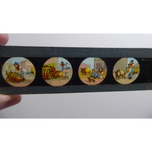 156 - A mixed lot: to include early Mickey Mouse toy slides by Ensign Ltd; a series of toy monochrome and ... 