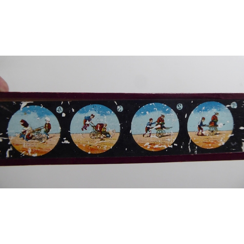 156 - A mixed lot: to include early Mickey Mouse toy slides by Ensign Ltd; a series of toy monochrome and ... 