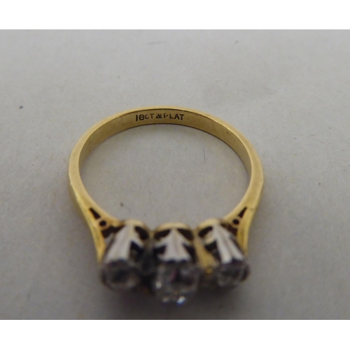 174 - An 18ct gold and platinum three stone diamond ring