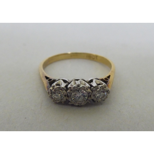 177 - An 18ct gold and platinum three stone diamond ring