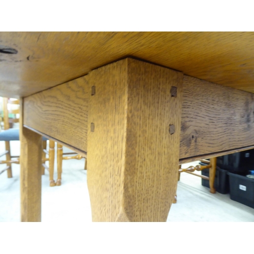 18 - A modern oak table, raised on block legs  30