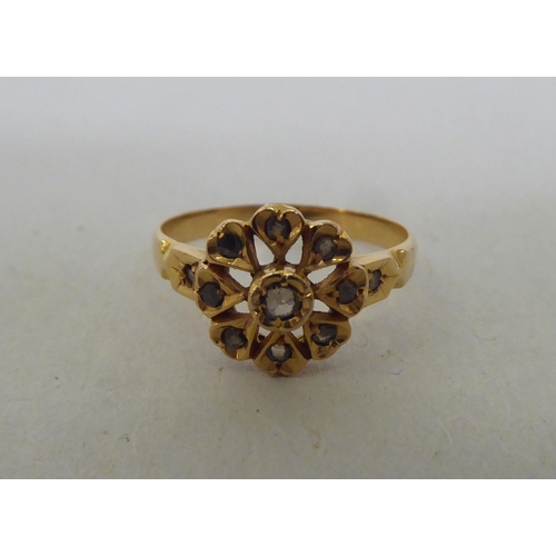 191 - A yellow metal floral design, diamond set ring