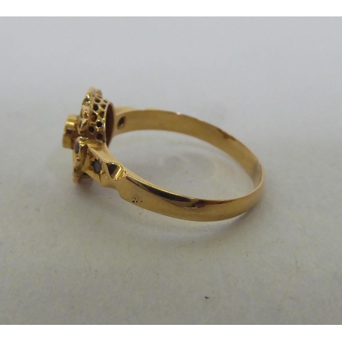 191 - A yellow metal floral design, diamond set ring