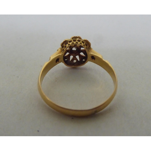 191 - A yellow metal floral design, diamond set ring