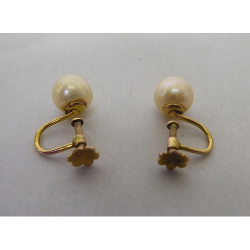 193 - A pair of pearl set, 9ct gold screw-back earrings