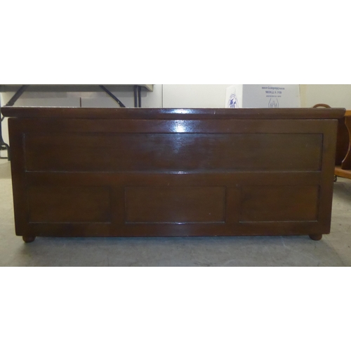 195 - A mid 20thC brown painted beech chest with straight sides and a hinged lid  17