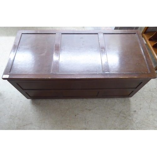 195 - A mid 20thC brown painted beech chest with straight sides and a hinged lid  17