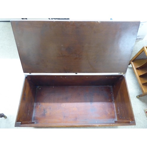 195 - A mid 20thC brown painted beech chest with straight sides and a hinged lid  17