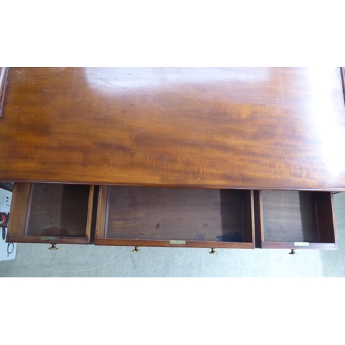 200 - A late Victorian mahogany kneehole five drawer writing table with a low part gallery border, raised ... 