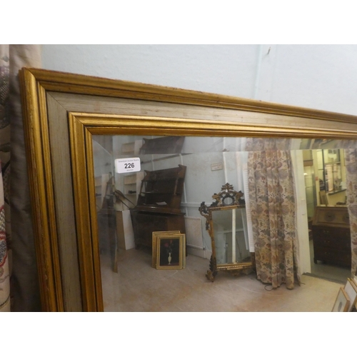 226 - A modern mirror, the bevelled plate set in a moulded and silvered gilt frame  66