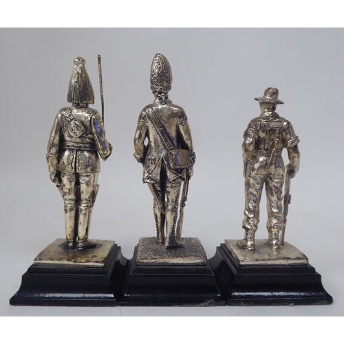 228 - A series of nine similar white metal models, British uniformed soldiers, on plinths  approx. 4.... 