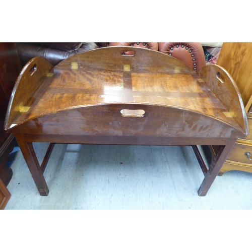 233 - A mid 20thC military design, brass hinged, mahogany tray table, the base raised on square legs ... 