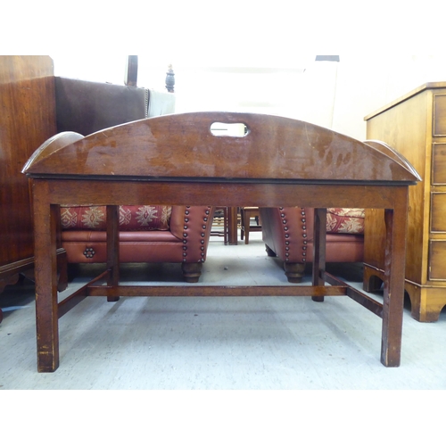 233 - A mid 20thC military design, brass hinged, mahogany tray table, the base raised on square legs ... 