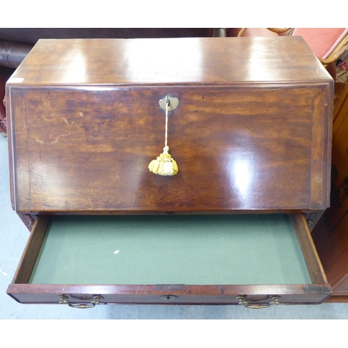 243 - A George III mahogany bureau, the fall-flap over four graduated drawers, raised on bracket feet ... 