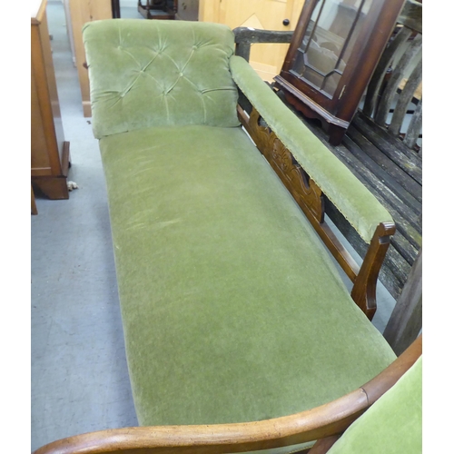 250 - An Edwardian style stained beech framed and green part-button upholstered chaise longue, raised on t... 