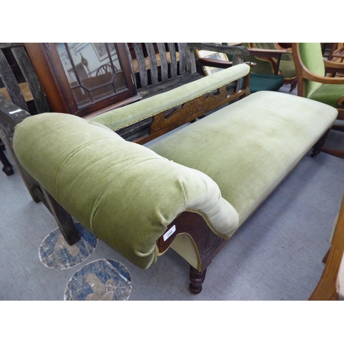 250 - An Edwardian style stained beech framed and green part-button upholstered chaise longue, raised on t... 