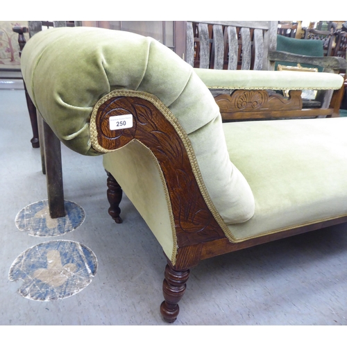 250 - An Edwardian style stained beech framed and green part-button upholstered chaise longue, raised on t... 