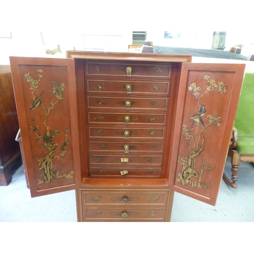 252 - A modern painted Chinese cabinet with a pair of doors, enclosing eight drawers, over three long draw... 