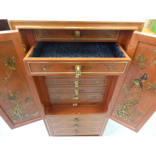 252 - A modern painted Chinese cabinet with a pair of doors, enclosing eight drawers, over three long draw... 