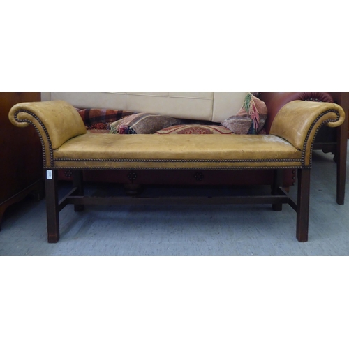 263 - An early 20thC window seat, stud upholstered in sun bleached brown hide, raised on square legs  54