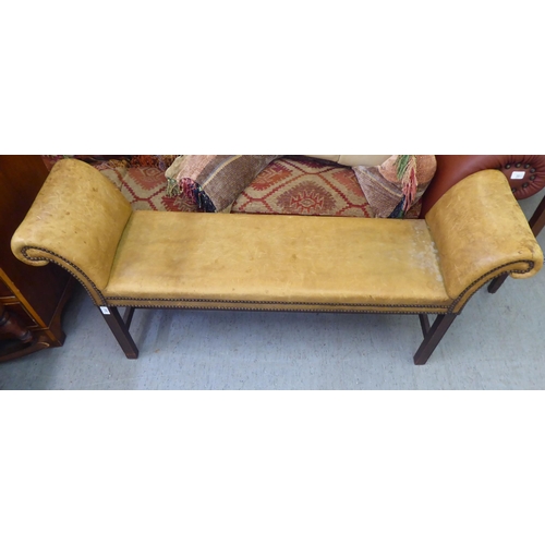 263 - An early 20thC window seat, stud upholstered in sun bleached brown hide, raised on square legs  54