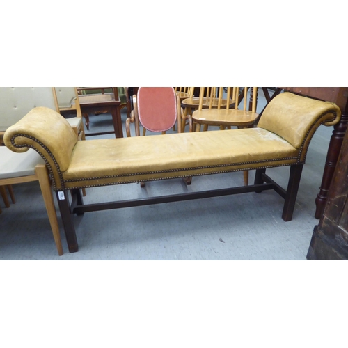 263 - An early 20thC window seat, stud upholstered in sun bleached brown hide, raised on square legs  54