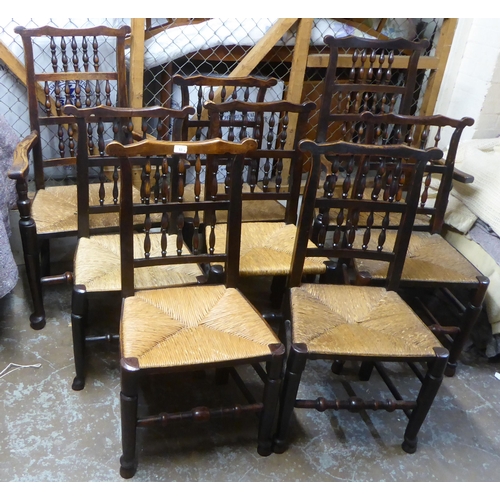 264 - A matched set of eight 18thC Lancashire ash framed spindle back dining chairs with woven rush seats,... 