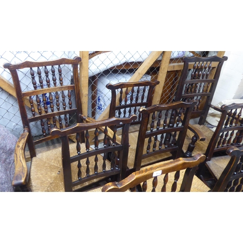 264 - A matched set of eight 18thC Lancashire ash framed spindle back dining chairs with woven rush seats,... 