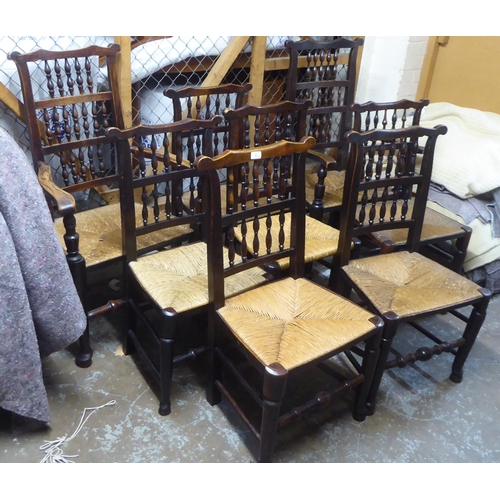 264 - A matched set of eight 18thC Lancashire ash framed spindle back dining chairs with woven rush seats,... 