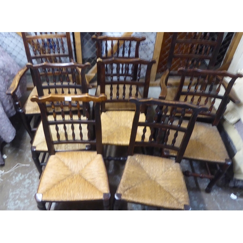 264 - A matched set of eight 18thC Lancashire ash framed spindle back dining chairs with woven rush seats,... 