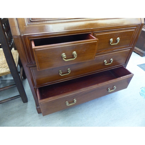 282 - A modern Chinese fruitwood bureau with a fall flap, over two short/two long drawers, raised on block... 