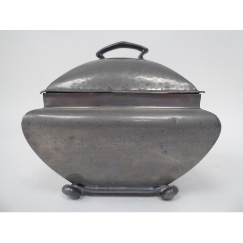 285 - An English Pewter caddy of square outline with a bulbous body, cover and top handle, on bun feet  im... 