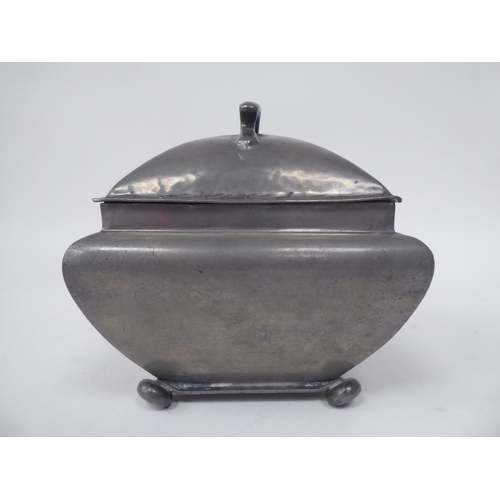 285 - An English Pewter caddy of square outline with a bulbous body, cover and top handle, on bun feet  im... 