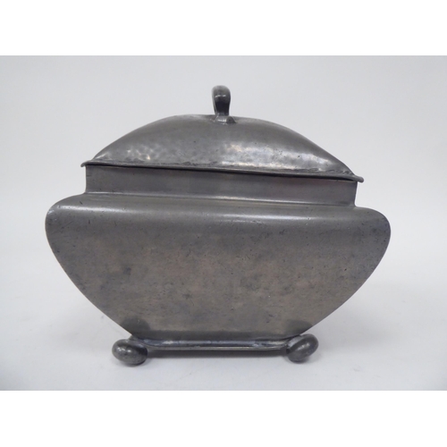 285 - An English Pewter caddy of square outline with a bulbous body, cover and top handle, on bun feet  im... 