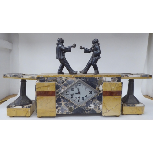 290 - An Art Deco marble three piece garniture, the clock surmounted by two clowns, playing bowls; the mov... 