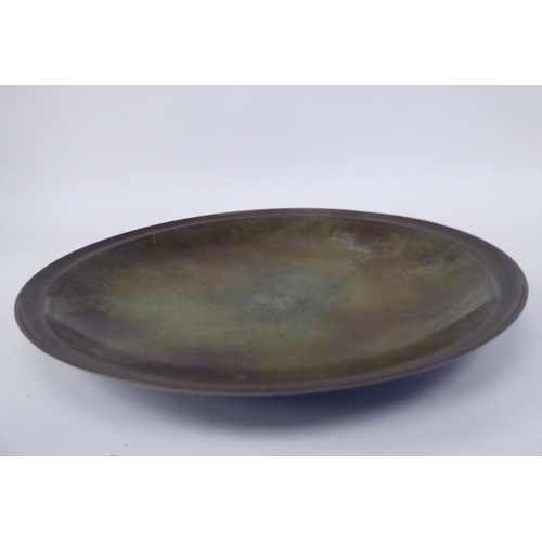 294 - A Just Anderson part-patinated green and brown bronze, footed, shallow dish with a double tramline e... 