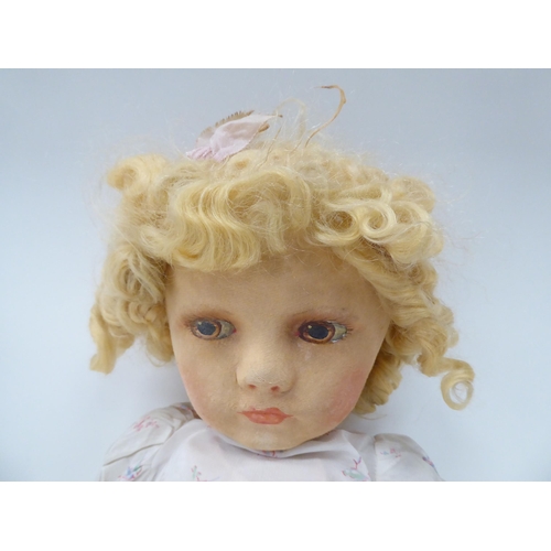295 - An early 20thC doll, the moulded and painted head on a fabric body  27