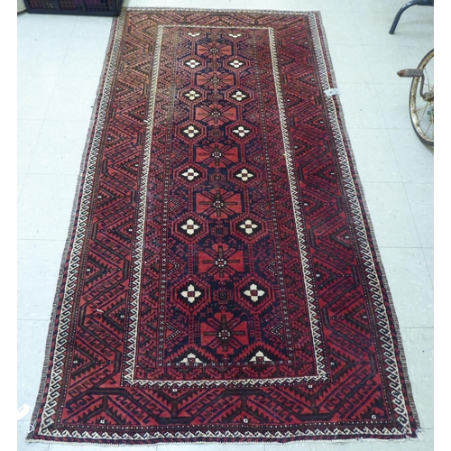 305 - A Persian rug with floral motifs, on a red ground  44