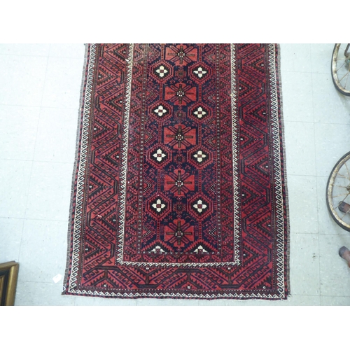 305 - A Persian rug with floral motifs, on a red ground  44