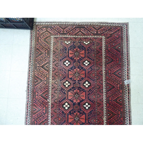 305 - A Persian rug with floral motifs, on a red ground  44