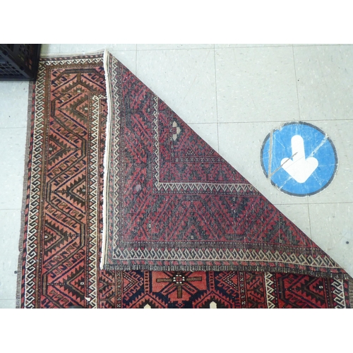 305 - A Persian rug with floral motifs, on a red ground  44