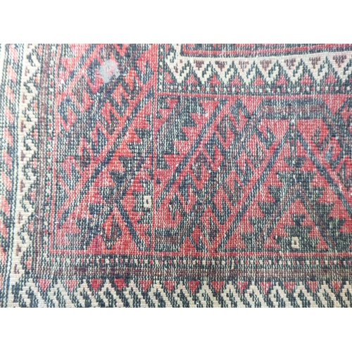 305 - A Persian rug with floral motifs, on a red ground  44